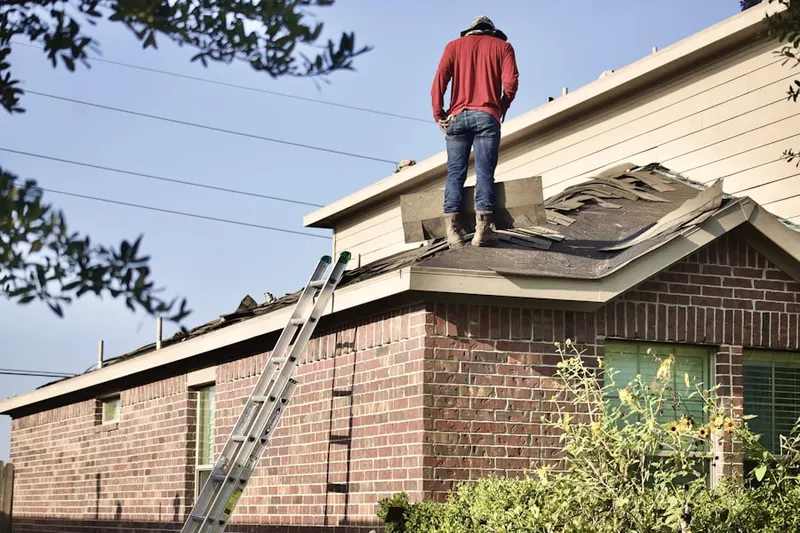 Professional roofer working on a residential roof in American Falls